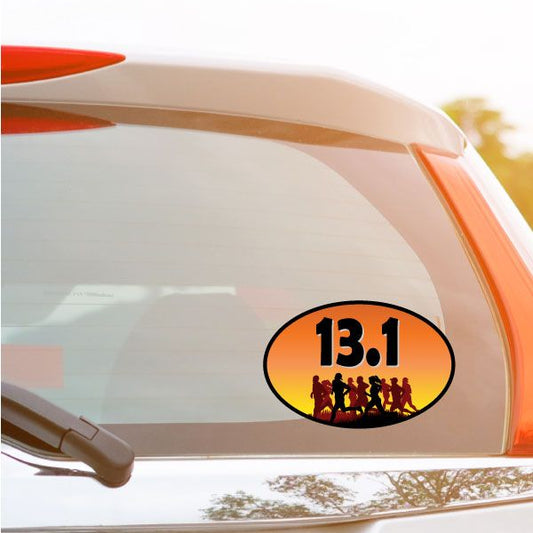 Oval 13.1 half marathon decal with runners in orange and black