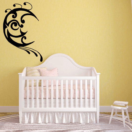 Abstract moon decal with a stylized black face and swirling details