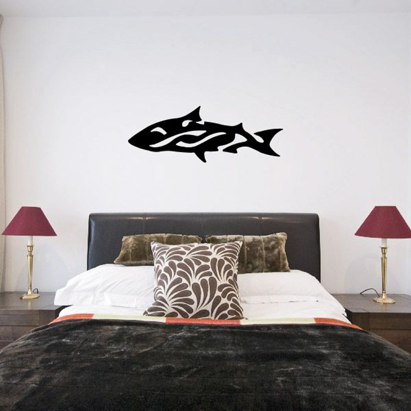Abstract twist fish decal with black stylized fish silhouette on light wall