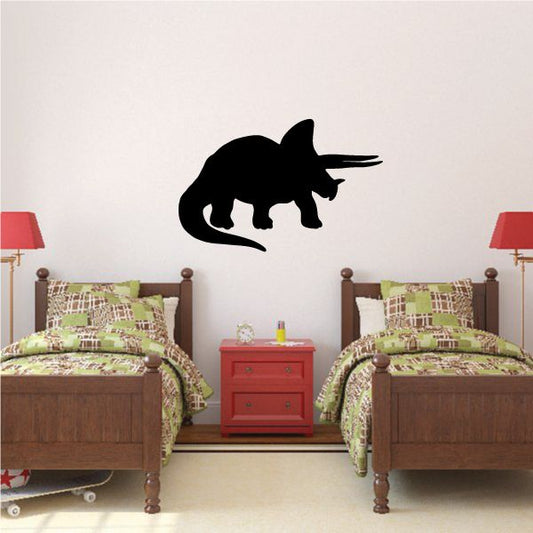 Aggressive triceratops wall decal in black, horned dinosaur silhouette