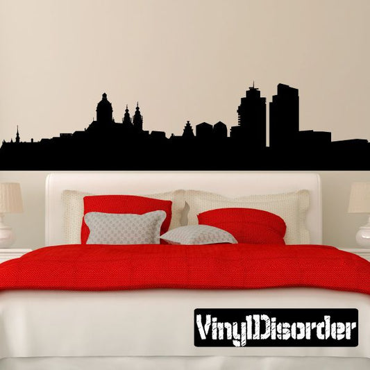 Black city skyline wall decal with tall towers silhouette above bed