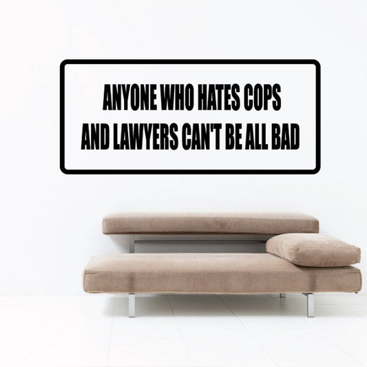 Wall decal with black border and bold quote text: 'ANYONE WHO HATES COPS AND LAWYERS'