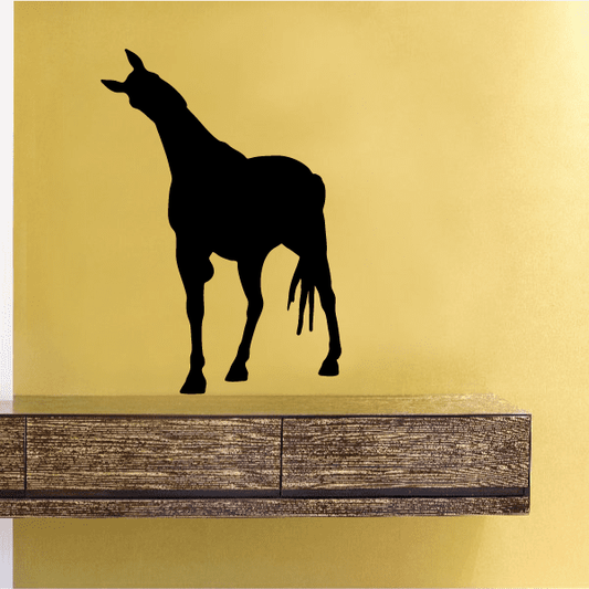 Black horse silhouette decal, head lowered and tail raised