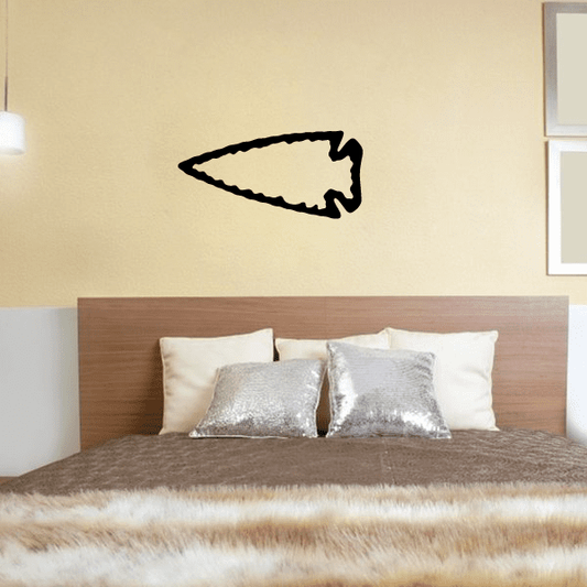 Left-pointing arrowhead wall decal in black, flat outline shape
