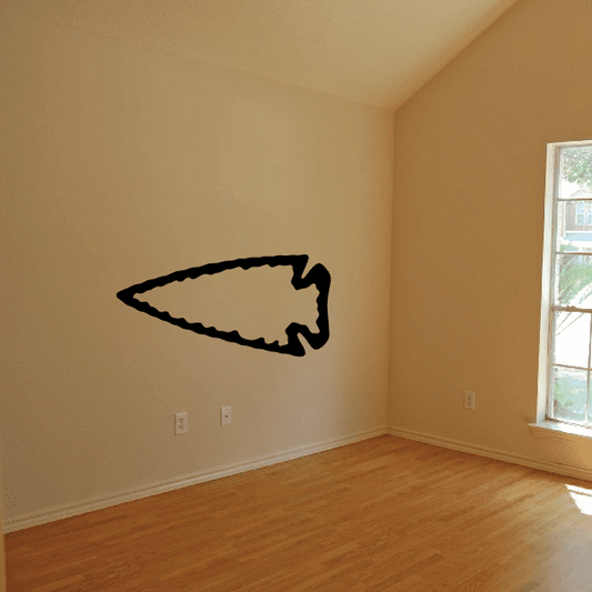 Black left-pointing arrowhead wall decal