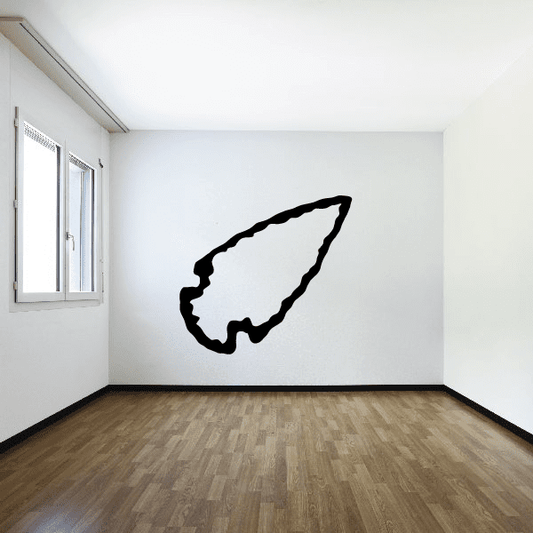 Right-pointing arrowhead wall decal, black vinyl shape on wall