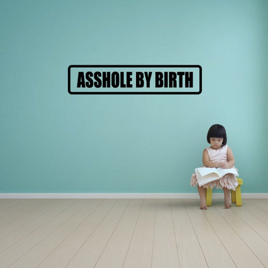 Vinyl wall decal with bold 'ASSHOLE BY BIRTH' text in black and white