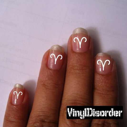 Astrology nail art stickers with white Aries-style curved glyph on nude nails