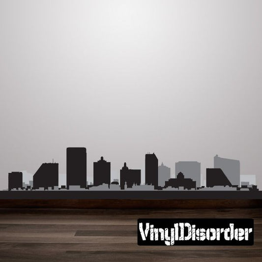 Printed die-cut decal with white stylized text on a black rectangle