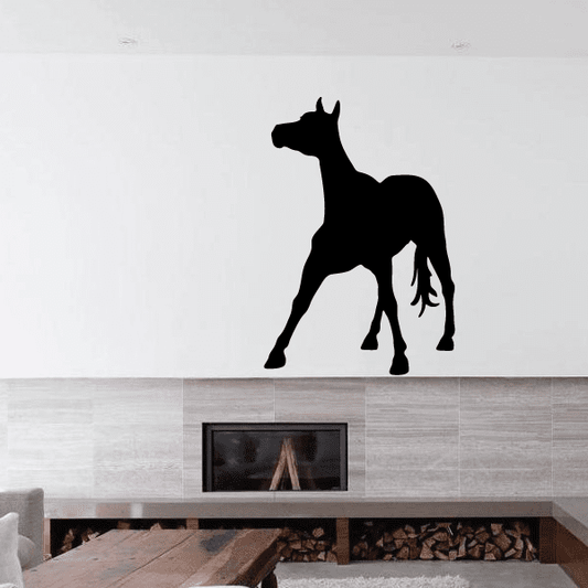 Black standing foal wall decal silhouette, balancing pose.
