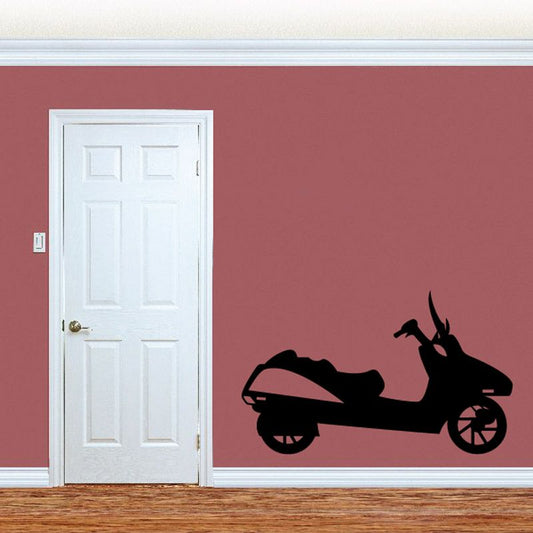 Black scooter decal with side-view riding silhouette on a flat surface.