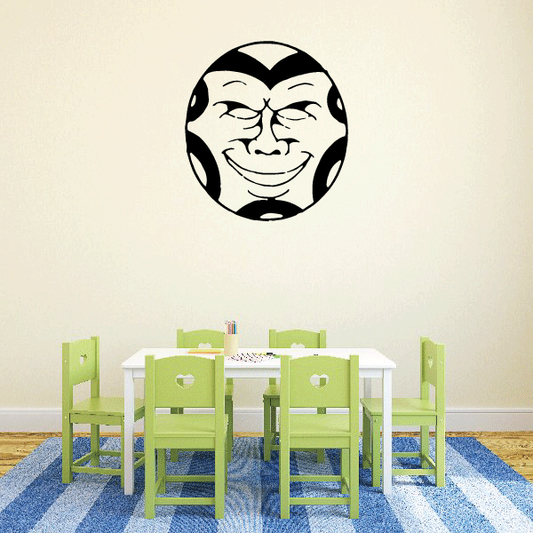 Stylized moon-face wall decal with smiling demon expression in black and cream
