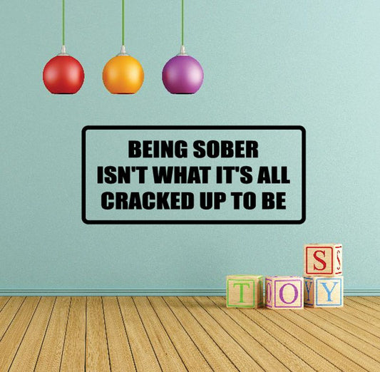 Black quote wall decal with bold white text: “BEING SOBER ISN’T WHAT IT’S ALL CRACKED UP TO BE”