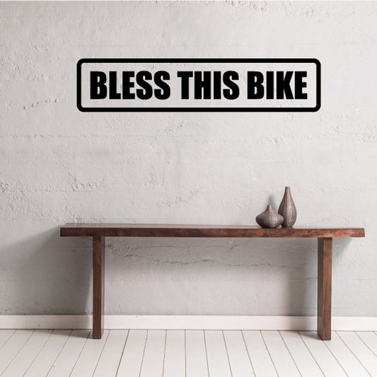 Bike decal with bold black “BLESS THIS BIKE” lettering in outlined badge