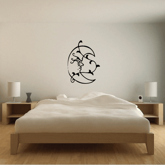 Wall decal of a black moon with blowing vine and curly figure detail