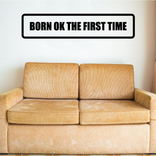 Black text wall decal: 'BORN OK THE FIRST TIME'