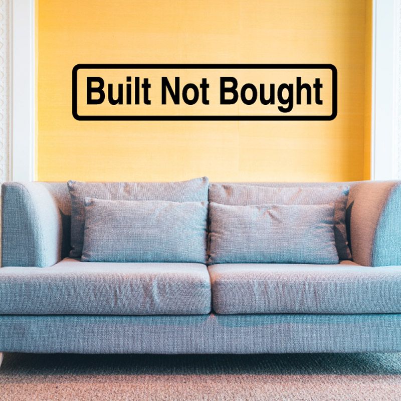 Built Not Bought wall decal with bold black text in rounded rectangle
