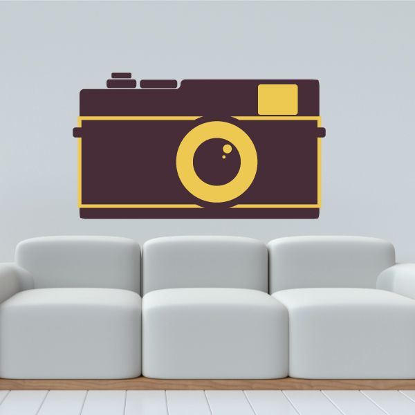 Camera wall decal of maroon camera with yellow outline and lens detail