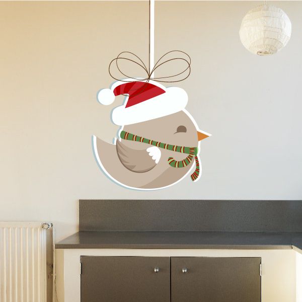 Christmas bird ornament sticker with bow, scarf, and hat on a crescent moon