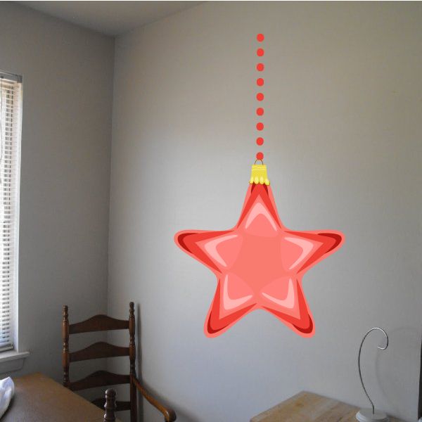 Coral red hanging Christmas star ornament with yellow top loop