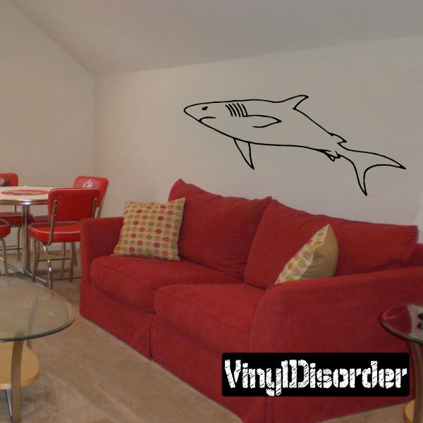 Shark wall decal with black outline and white fill, swimming over a couch