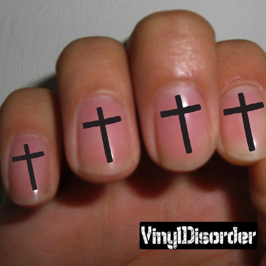 Fingernail art sticker set with black cross decals on pink nails