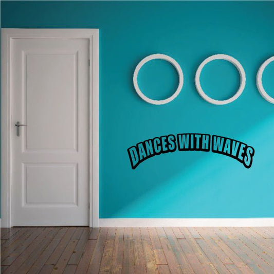 Wall decal with “DANCES WITH WAVES” text and three white circular rings