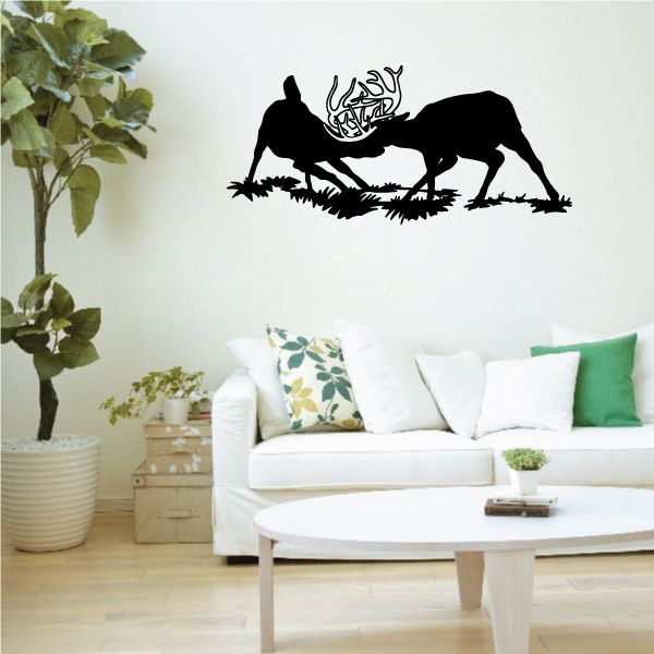 Deer fight wall decal with black deer silhouettes and antlers over grass