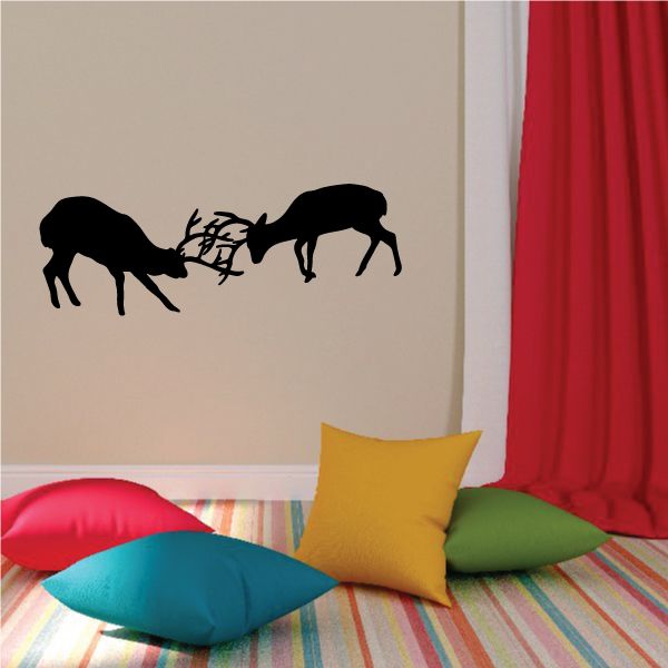Deer fight duel decal with black silhouettes of two antlered deer facing off