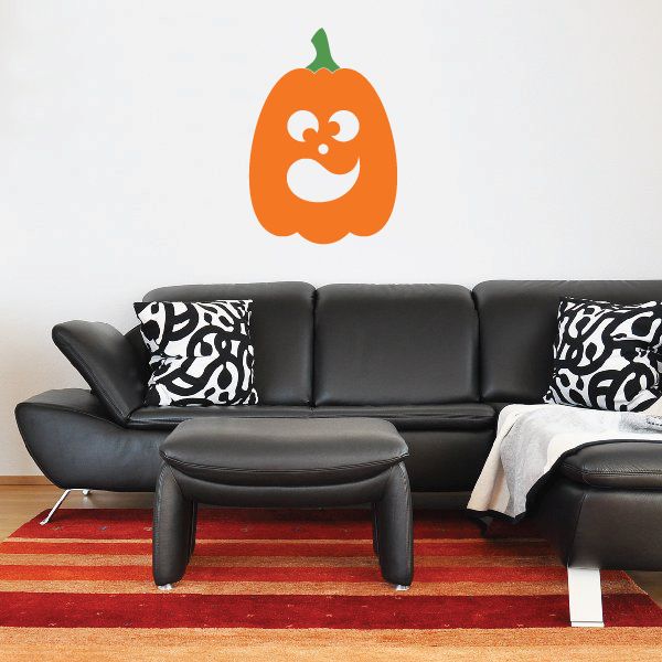 Orange jack-o-lantern face wall decal with green stem and white grin