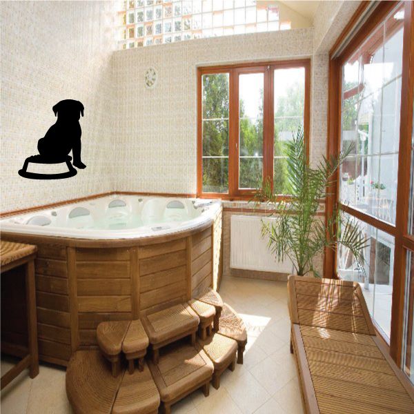 Black dog sitting by food bowl wall decal