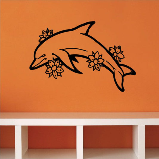 Dolphin vinyl wall decal with three dolphins and flower accents, black outline