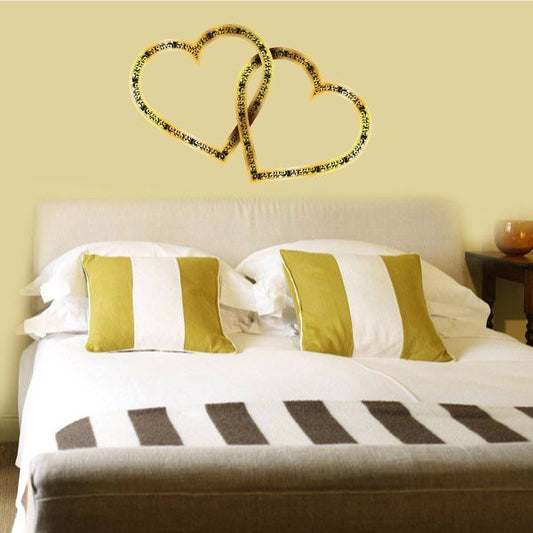 Double heart Valentine decal with glittery gold outline on wall
