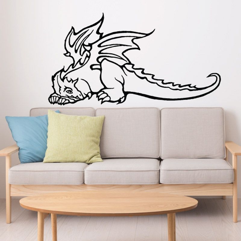 Dragon wall decal vinyl graphic of black dragon with wings spread above sofa
