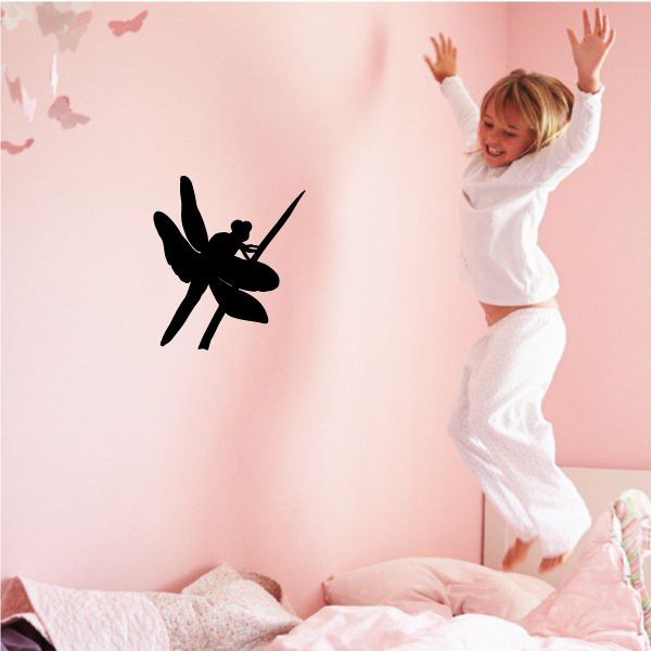 Black dragonfly perched on branch wall decal
