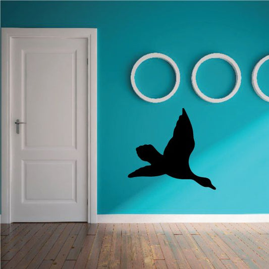 Duck wall decal with black flying duck silhouette and white circular accents