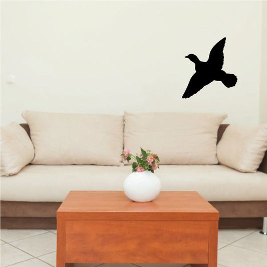 Duck wall decal, black duck silhouette on wall above couch