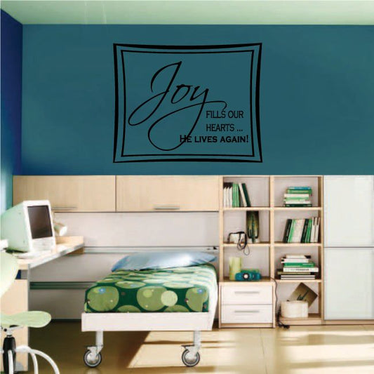 Rectangular wall decal with black “Joy” script and “He lives again” text