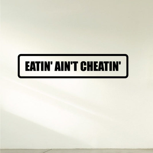 Vinyl wall decal: bold black 'EATIN AIN'T CHEATIN'' text in a rectangle