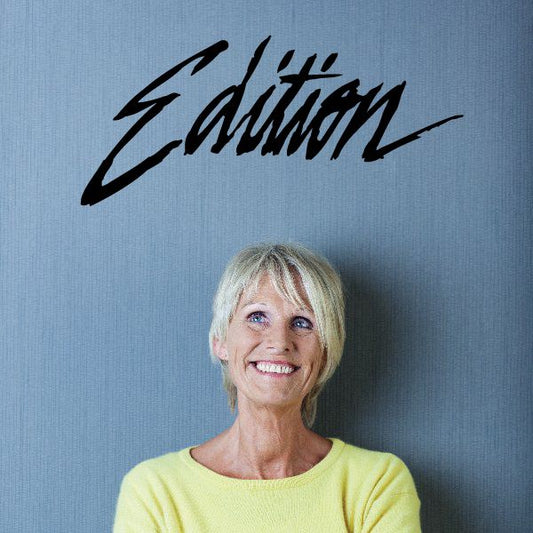 Edition decal with black cursive lettering on a light background