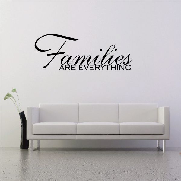 Wall decal with black script reading "Families are everything"