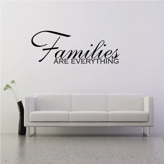 Wall decal with black script reading "Families are everything"