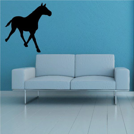 Black walking horse wall decal, mid-stride silhouette in profile.