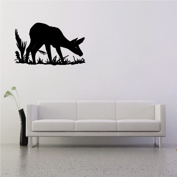 Black fawn and grass sniffing wall decal with silhouette design