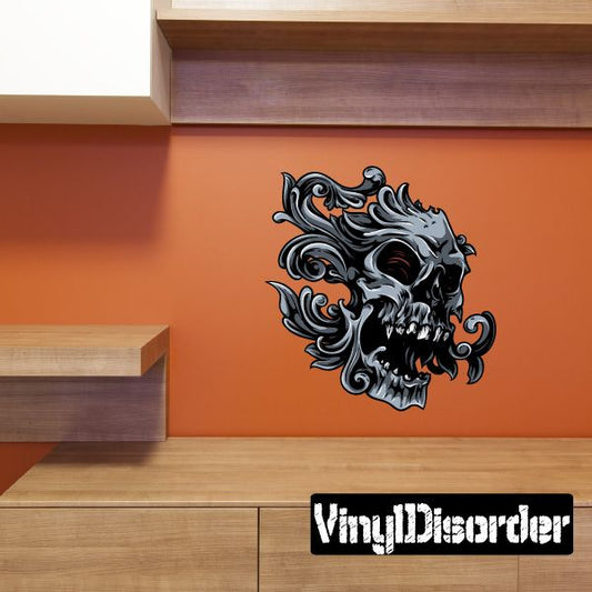 Ornate skull sticker with black filligree details and curled flames