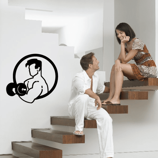 Fitness wall decal: black vinyl outline of a flexing figure with dumbbells