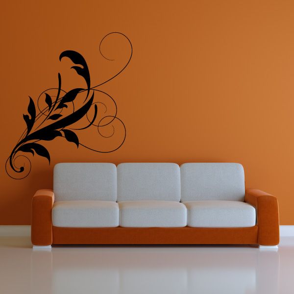 Black floral damask wall decal with swirling vine design above a gray sofa