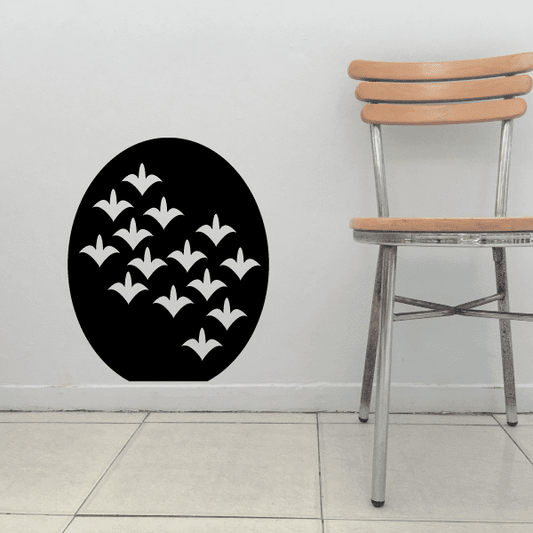 Wall decal with a black circular design and white floral motifs