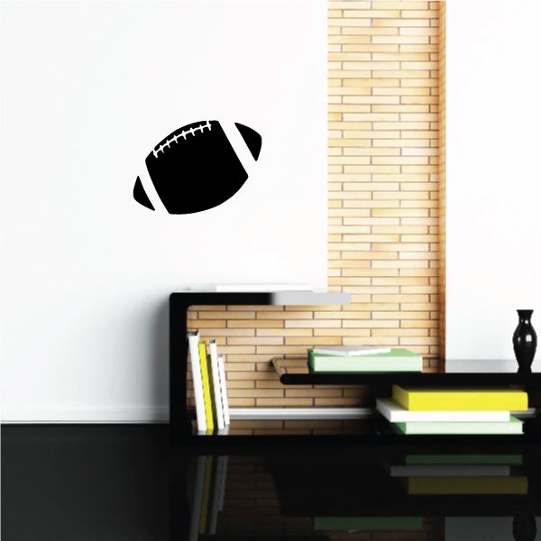 Black flying football wall decal with stitched white laces
