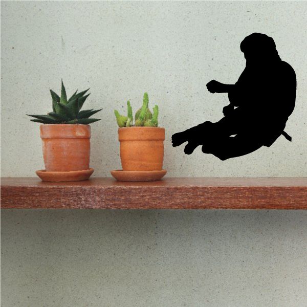 Wall decal with black silhouette of a person delivering a flying kick